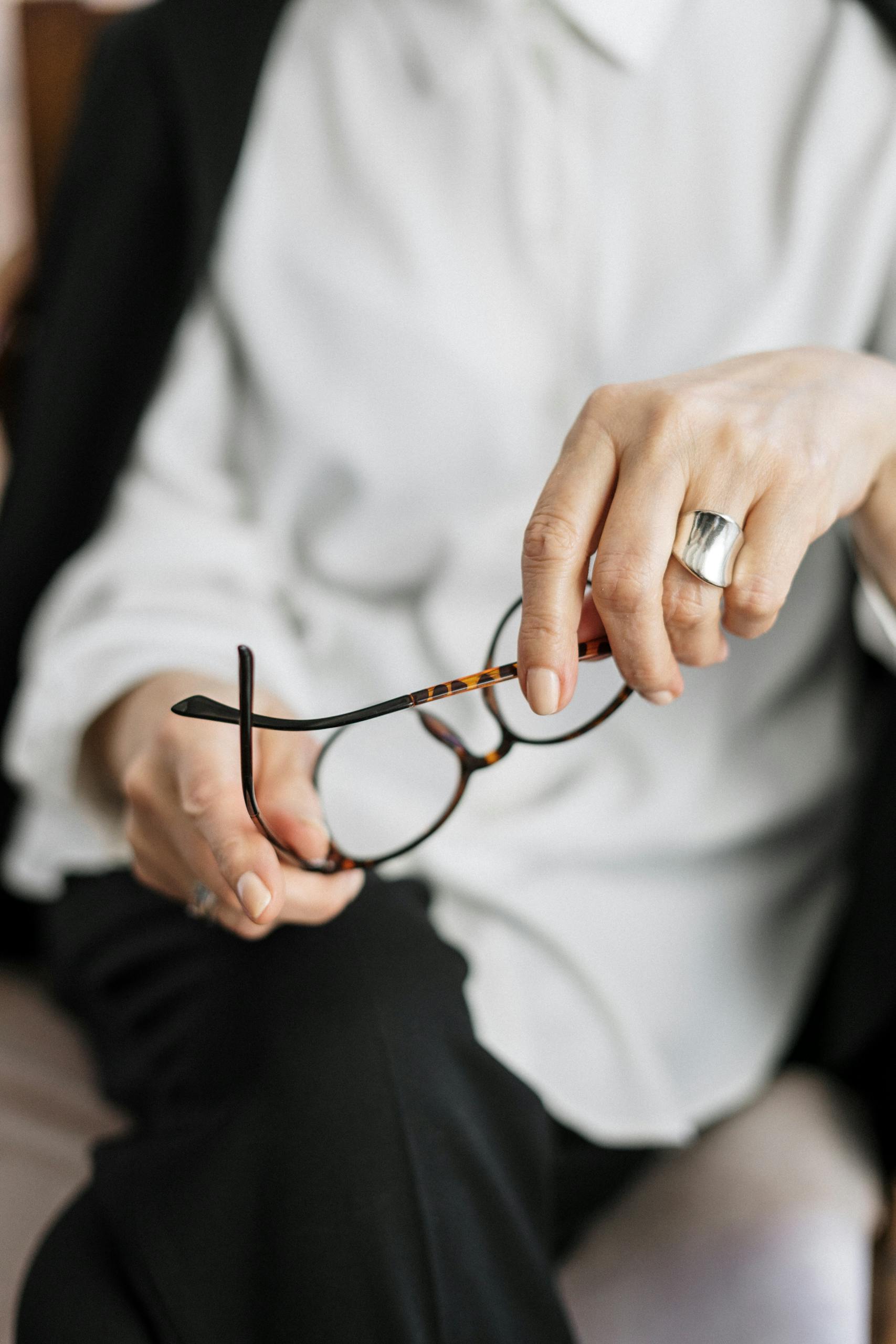 Person Holding Brown Framed Eyeglasses