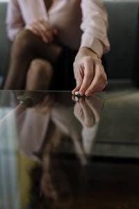 Person in White Long Sleeve Shirt Holding Silver and Black Scissors