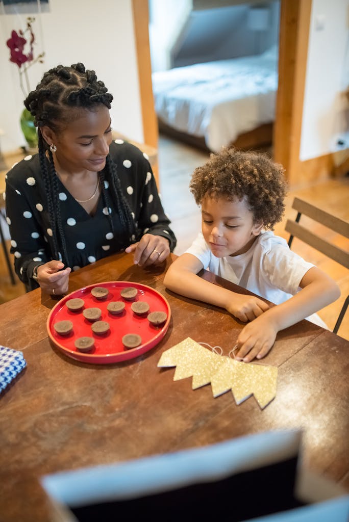 Mom and child baking cookies at home, enjoying quality family time in cozy interior.