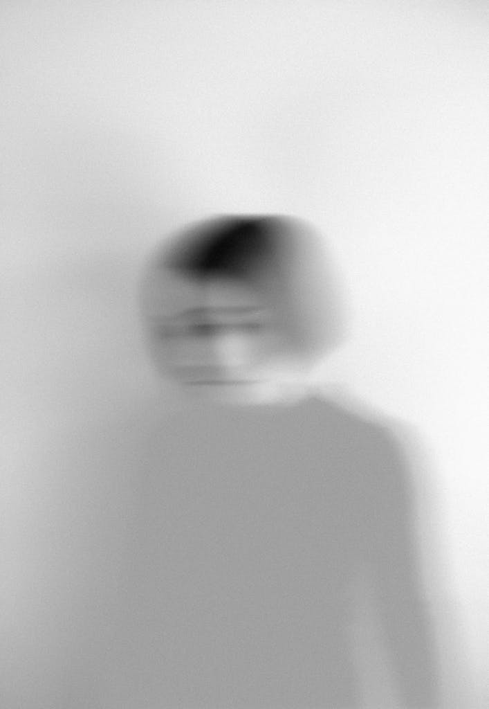 Photo by Elīna Arāja | Fuller Life Family Therapy Artistic blurred grayscale portrait capturing motion and emotion.